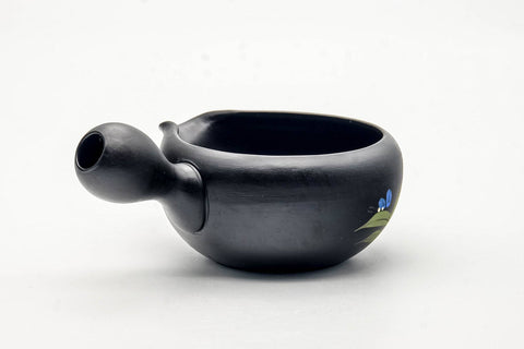 Angled view into the mouth of the black yuzamashi, revealing the glazed interior.