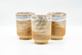 Three Hagi-yaki teacups arranged side by side showing the milky white glaze
