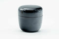 Small black-urushi ko-natsume matcha caddy, lid on, front view of the glossy black body