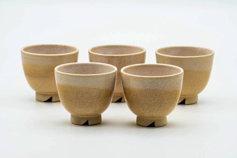 The small cups arranged in a row, front view.