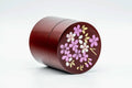 The canister with lid off, showing the blossom-decorated lid and the gold-rimmed inner lid