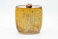Front view of the lidded mizusashi showing streaked brown glaze over a cylindrical body.