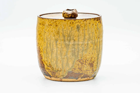 Front view of the lidded mizusashi showing streaked brown glaze over a cylindrical body.