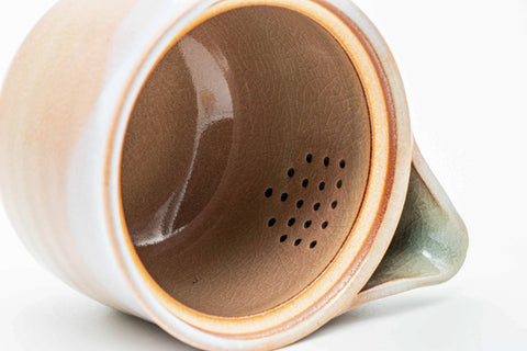 Interior view of the pink-beige Hagi-yaki kyusu showing the perforated do-ake strainer holes inside