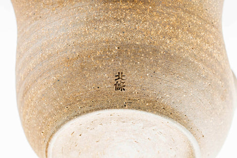 Underside of the katakuchi showing the pale clay foot.