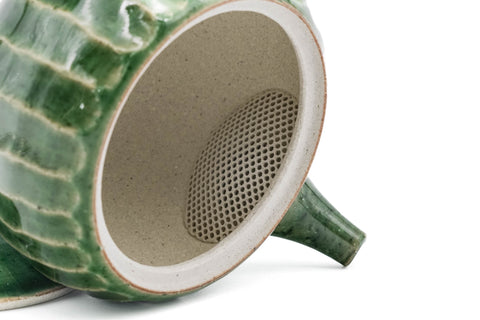 Green faceted Oribe Tokoname teapot, open view showing the pale interior and spout