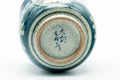 The cup tipped to reveal the foot and maker's stamp.