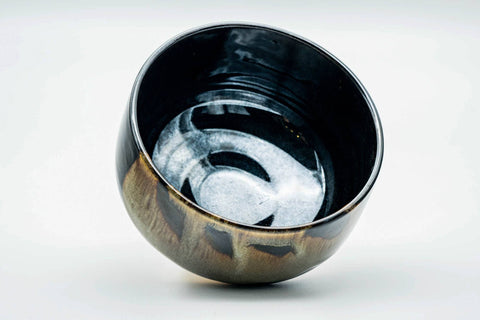 Overhead view looking into the glossy dark interior of the chawan
