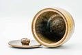 Jar tipped to show the open mouth with the lid set beside it, glazed interior visible.