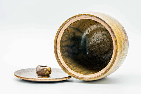 Jar tipped to show the open mouth with the lid set beside it, glazed interior visible.
