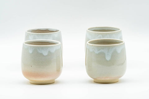 Japanese Teacups - Set of 4 Tsubaki Kiln Hagi-yaki Yunomi - 90ml - two of the four beige and white drip-glazed teacups arranged together, front view