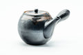 Angled view with the side handle at right and the spout to the lower left.
