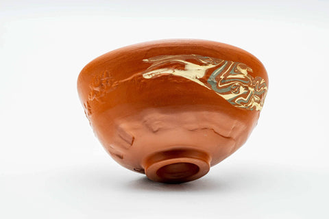 Tilted view of the Tokoname nerikomi chawan showing the interior, rim and gold motif
