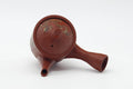 Top-down view showing the lid, spout, side handle, and abstract decoration.