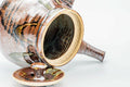 The kyusu with the lid removed, showing the wide opening; the lid rests beside it.