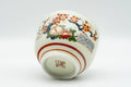 Japanese Teacup - Beige Red Chrysanthemums Kutani-yaki Yunomi - 130ml - tilted view showing footring and floral motif