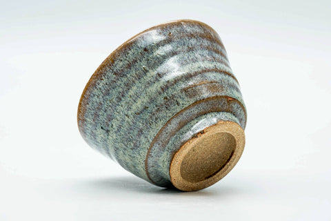 Teacup tilted to show the lower body and unglazed foot.