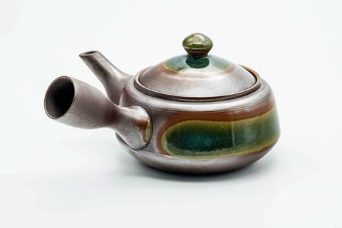 Rear three-quarter view of the banko kyusu showing the handle and green glaze.