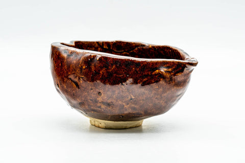 Side view of the burgundy katakuchi showing its rounded irregular form and pouring spout