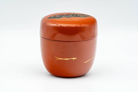 Japanese Natsume - Orange Gold Floral Lacquered Matcha Tea Caddy - 100ml - front three-quarter view of the closed caddy showing the orange urushi lacquer body and decorated lid
