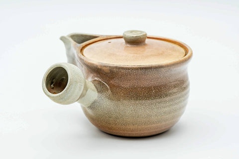 Beige weathered Hagi-yaki kyusu, side profile with the spout to the left and handle to the right