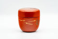 Japanese Natsume - Orange Lacquer Gold Geometric Matcha Tea Caddy - 100ml - front view of the closed caddy with gold motif