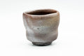 Waisted Bizen-yaki yunomi teacup with a wood-fired purplish-grey surface, front view.
