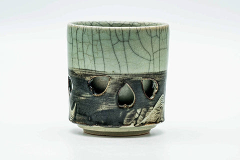 Side view of the teacup, showing the horse motif and crackle glaze.