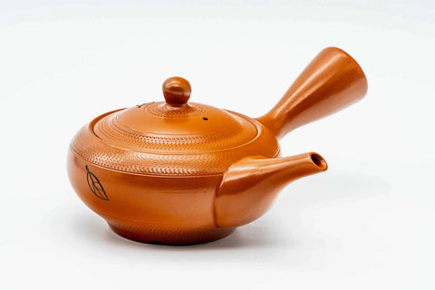 Red shudei Tokoname kyusu, front view with the spout pointing left and handle to the right