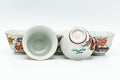 Two teacups with one tipped on its side to reveal the glazed interior and foot.