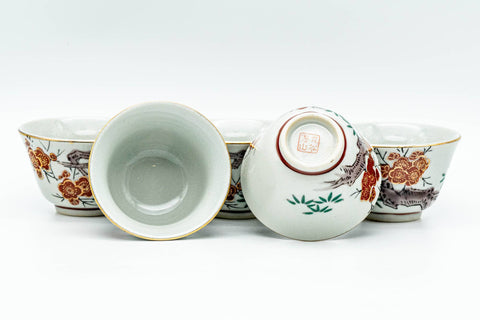 Two teacups with one tipped on its side to reveal the glazed interior and foot.