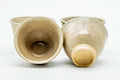 The cups with one tipped to show the glazed interior and foot.