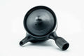 Overhead view of the black kyusu, lid on, showing the handle and spout.