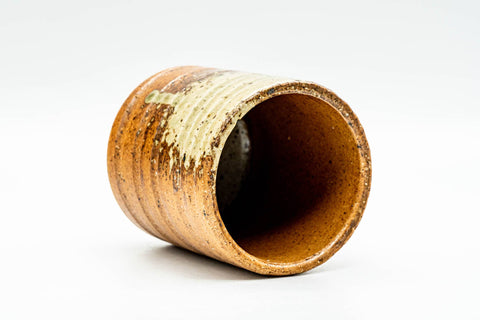 Angled overhead view into the Shigaraki yunomi, revealing the smooth glazed cream interior and rim