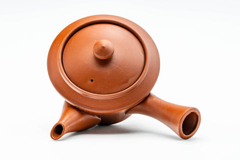 Overhead view of the teapot with the knobbed lid in place and handle extended.