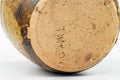 Overhead view of the unglazed clay base on the underside of the water jar.