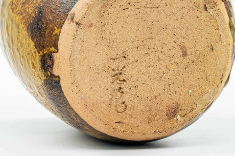 Overhead view of the unglazed clay base on the underside of the water jar.