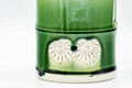 Close-up of the bamboo-form body showing the molded shell relief and green glaze.