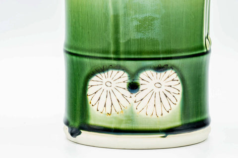 Close-up of the bamboo-form body showing the molded shell relief and green glaze.