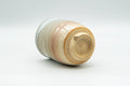 Japanese Teacup - Beige, Peach, and White Hagi-yaki Yunomi - 180ml - tilted view showing the unglazed foot