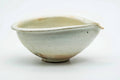 Side view of the beige katakuchi with the pouring spout to the right.