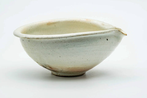 Side view of the beige katakuchi with the pouring spout to the right.