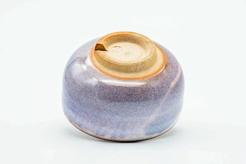 Teacup tilted to show the lower body and unglazed foot.
