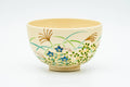 Japanese Matcha Bowl - Akatsuki Kiln - Beige Floral Kyo-yaki Chawan in Wooden Box - 300ml - side view showing painted grasses and flowers around the beige body
