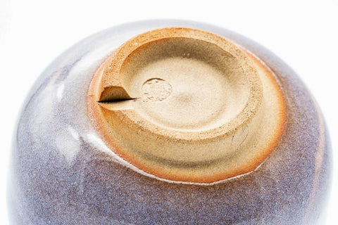 Underside of the teacup, showing the unglazed clay foot ring.