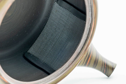 Interior view of the dark green Tokoname kyusu showing the integrated ceramic mesh filter wall