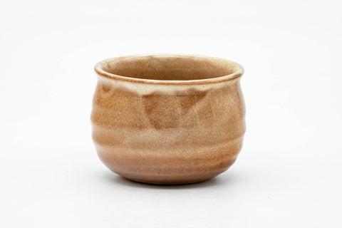 Front view of the cup body showing the horizontal ribbing and drip glaze.