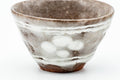 Front close-up of one yunomi showing the glaze texture and speckling.