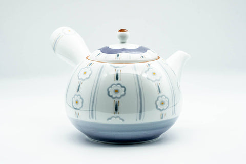 Another side angle of the teapot showing the handle and painted body decoration