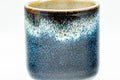 Tezumi — Japanese Teacup - Black and Blue Glazed Tsutsu-gata Yunomi - 140ml — tipped to show the interior
